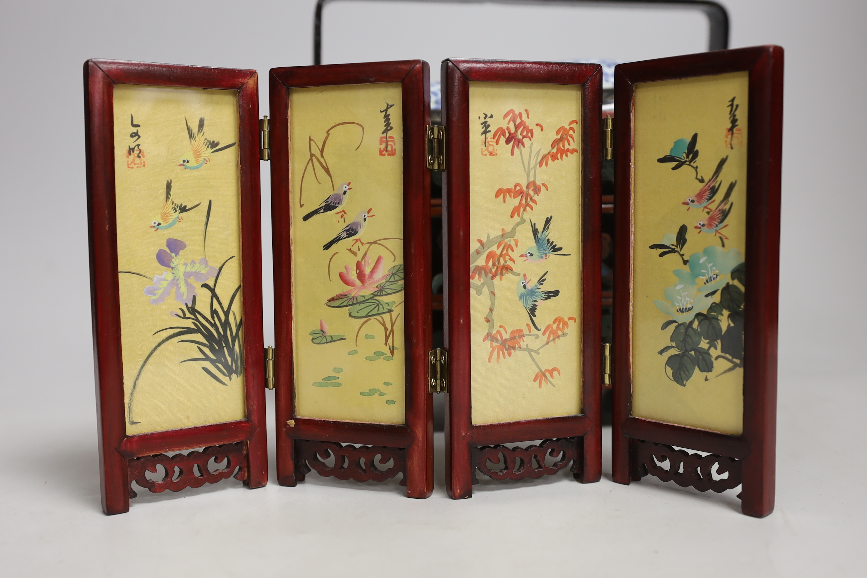 A Chinese lacquer and porcelain inset three tier stacking box, together with a hardstone inset brass box and miniature screen